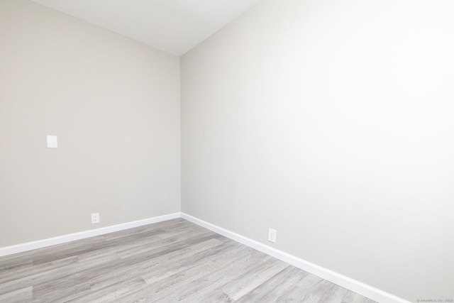 spare room with light hardwood / wood-style flooring