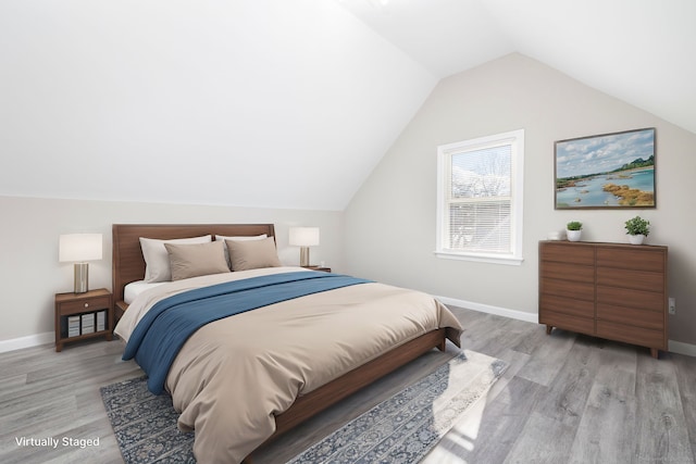 bedroom with hardwood / wood-style flooring and vaulted ceiling