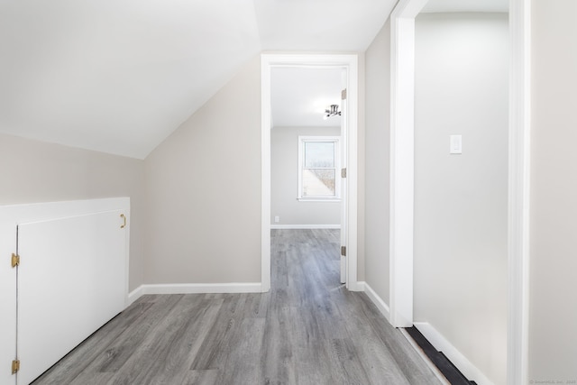 bonus room featuring vaulted ceiling and light hardwood / wood-style flooring