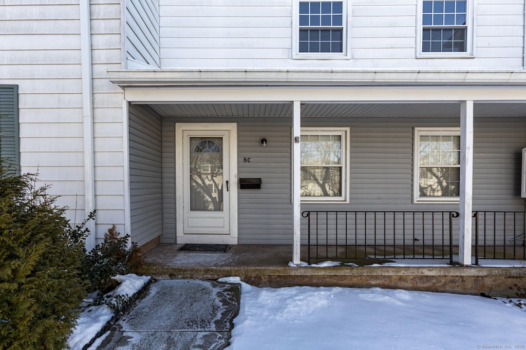 view of snow covered property entrance