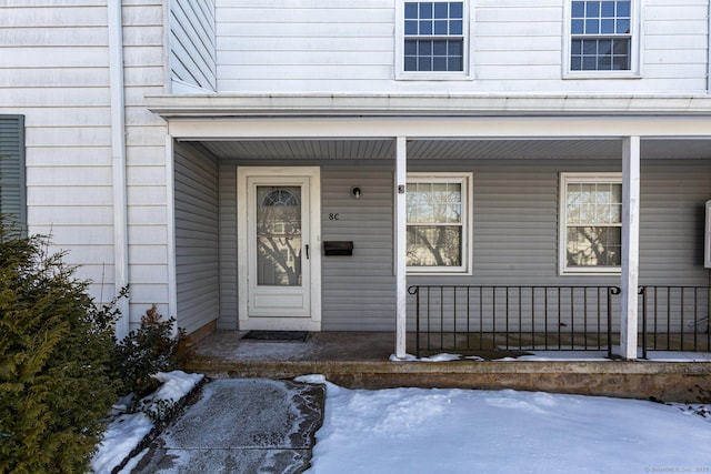 view of snow covered property entrance