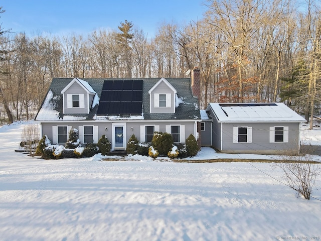 cape cod-style house with solar panels