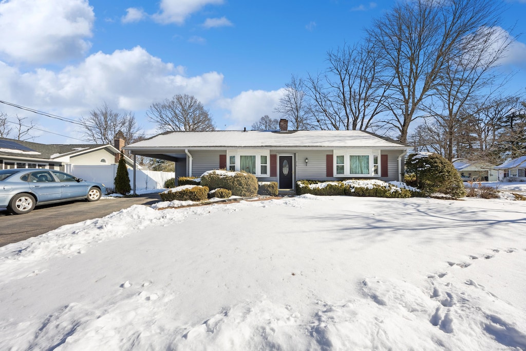 single story home featuring a carport