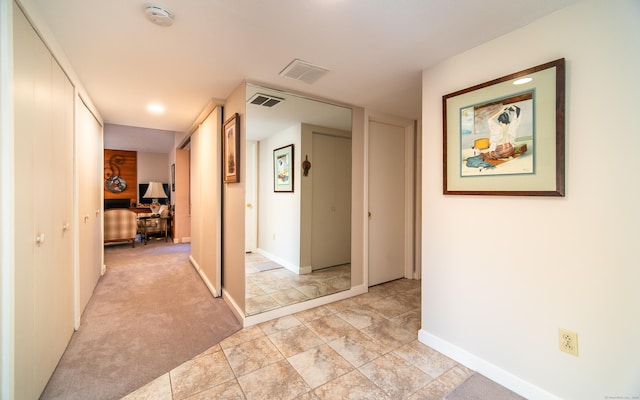 hallway with light colored carpet