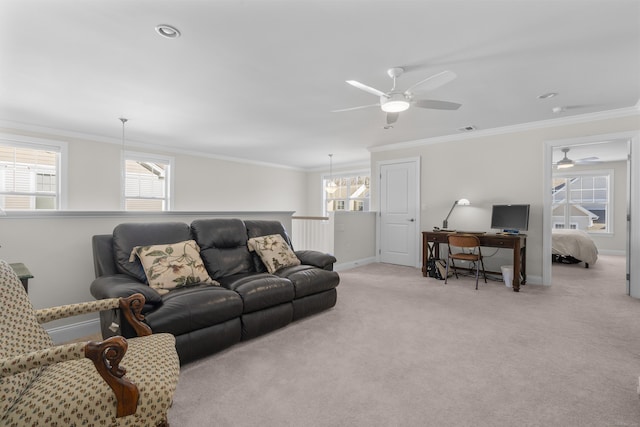 living room featuring ornamental molding, a healthy amount of sunlight, and light colored carpet