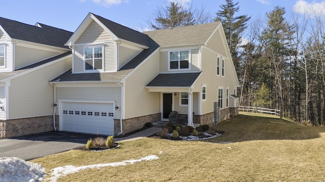 view of front of property featuring a garage and a front yard