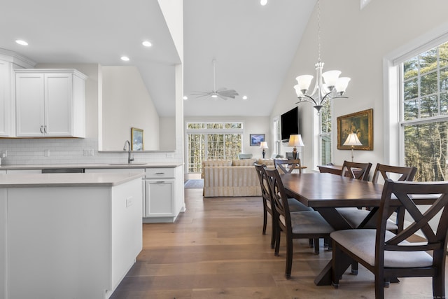 dining space with a healthy amount of sunlight, sink, dark wood-type flooring, and ceiling fan