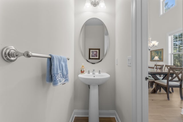 bathroom featuring hardwood / wood-style flooring, sink, and a chandelier