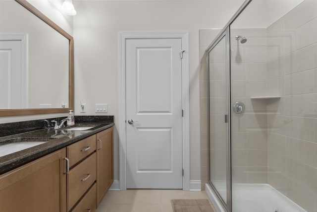 bathroom with vanity, a shower with shower door, and tile patterned flooring