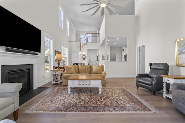 living room with dark hardwood / wood-style flooring and ceiling fan