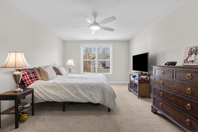 bedroom with light carpet and ceiling fan