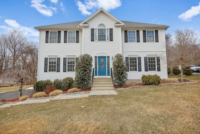 colonial inspired home with a front yard