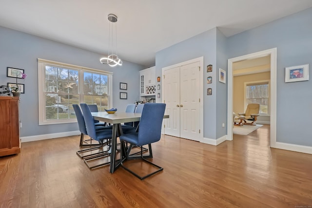 dining area with an inviting chandelier and light wood-type flooring