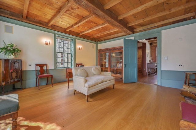 sitting room with beam ceiling, light wood-type flooring, and wooden ceiling