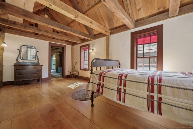 bedroom with hardwood / wood-style floors, wood ceiling, and lofted ceiling with beams