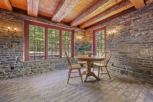 unfurnished sunroom with beamed ceiling and wood ceiling