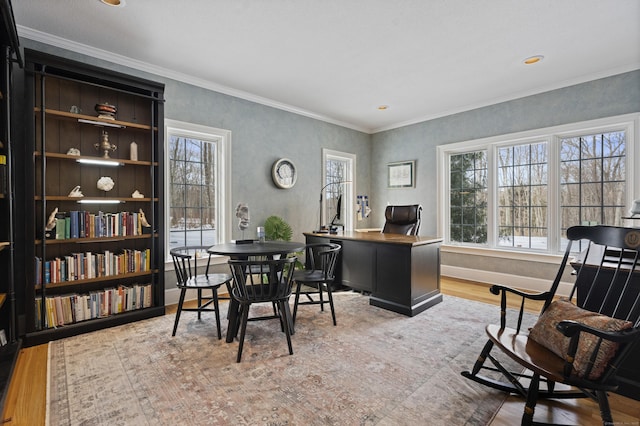 home office with a healthy amount of sunlight, crown molding, baseboards, and wood finished floors