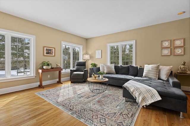 living area with light wood-type flooring and baseboards