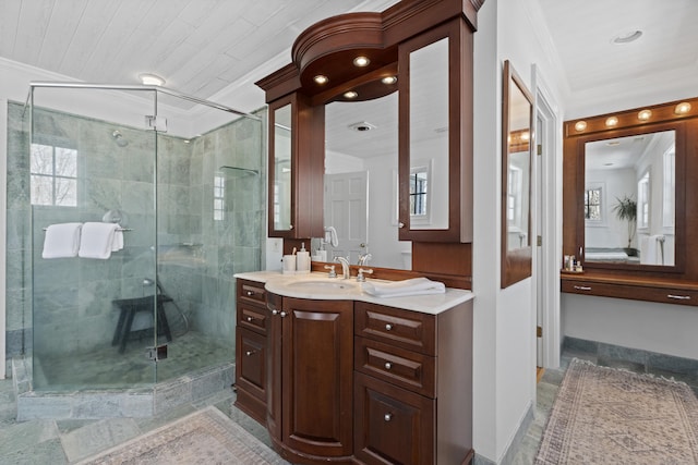 bathroom featuring ornamental molding, a shower stall, vanity, and a healthy amount of sunlight