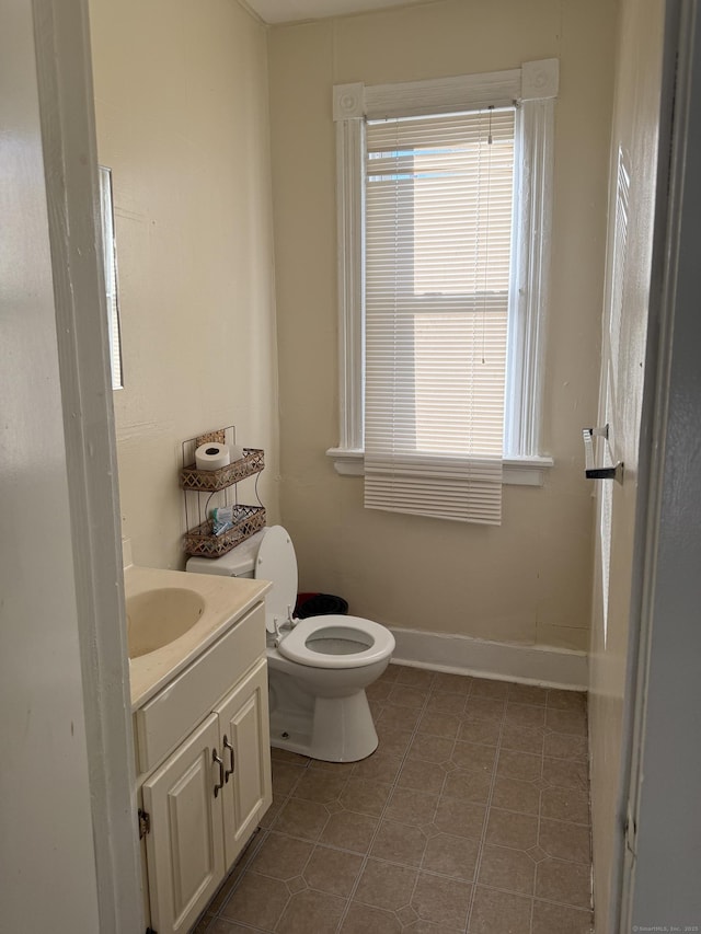 bathroom with vanity, tile patterned floors, and toilet