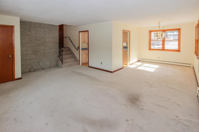 empty room featuring brick wall, a baseboard heating unit, and light carpet