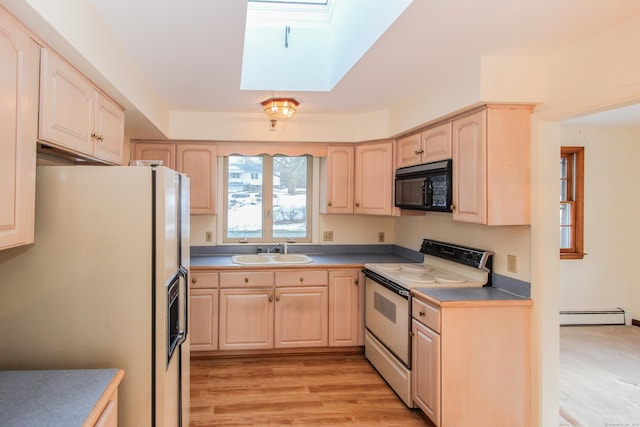 kitchen featuring sink, a skylight, light brown cabinets, white appliances, and a baseboard heating unit