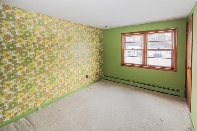 unfurnished room with a baseboard radiator and carpet floors