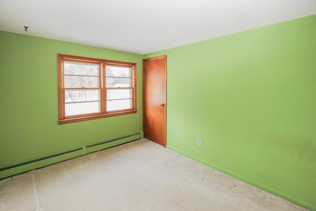 empty room featuring light colored carpet and a baseboard heating unit