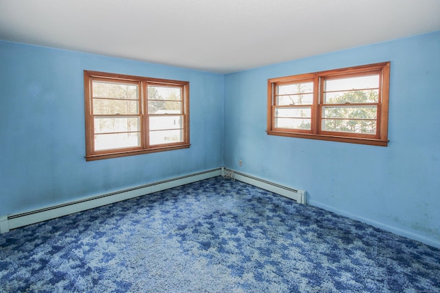 carpeted spare room featuring a baseboard radiator and plenty of natural light