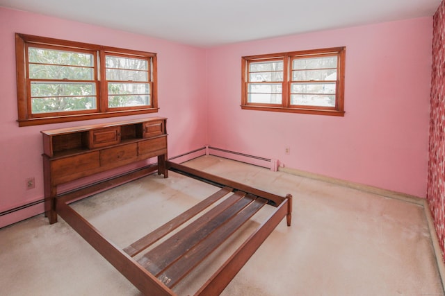 carpeted bedroom featuring a baseboard heating unit