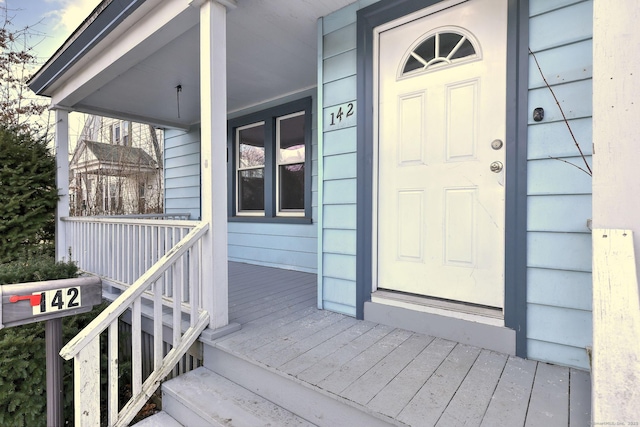 view of exterior entry with a porch