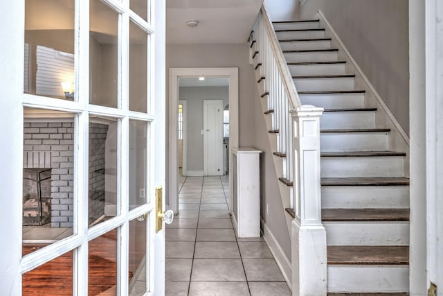 stairway featuring tile patterned floors and french doors