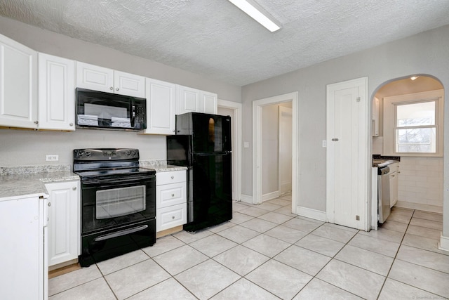 kitchen featuring light tile patterned floors, a textured ceiling, black appliances, and white cabinets