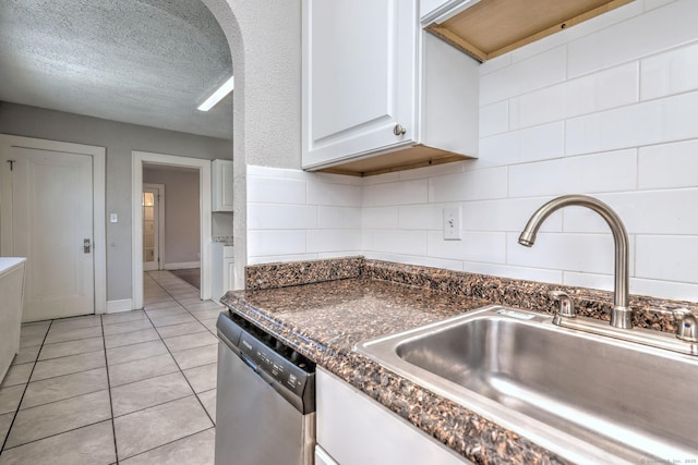 kitchen featuring sink, dishwasher, tasteful backsplash, a textured ceiling, and white cabinets