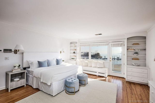 bedroom with hardwood / wood-style flooring, access to exterior, crown molding, and a baseboard heating unit