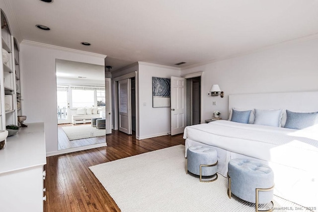 bedroom featuring ornamental molding, dark hardwood / wood-style flooring, and a closet