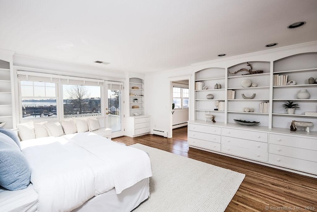 bedroom featuring dark wood-type flooring, a baseboard radiator, and ornamental molding