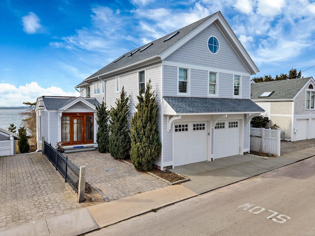 view of property featuring french doors and a garage