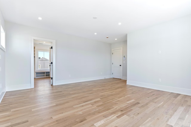 unfurnished room with light wood-style floors, baseboards, and recessed lighting