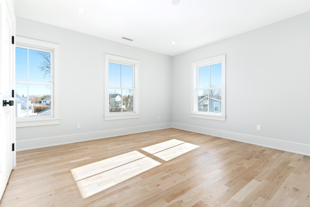 spare room featuring recessed lighting, baseboards, light wood finished floors, and visible vents
