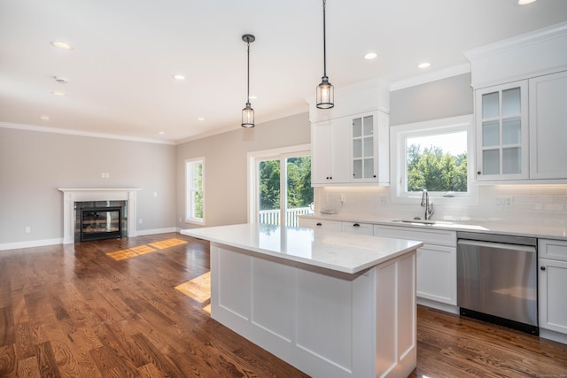 kitchen with backsplash, stainless steel dishwasher, and white cabinets