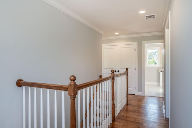 hall featuring ornamental molding and dark hardwood / wood-style flooring