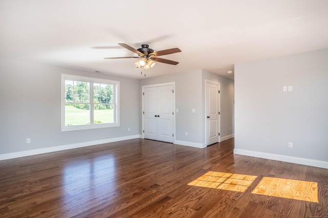 unfurnished room with dark wood-type flooring and ceiling fan