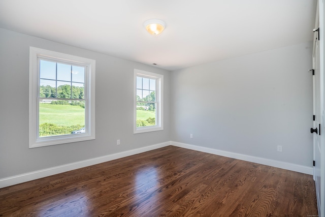 empty room with dark wood-type flooring