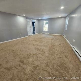 basement with carpet floors and a baseboard radiator