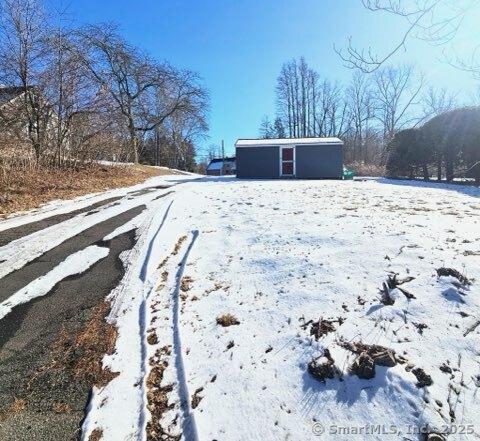 yard covered in snow with an outdoor structure