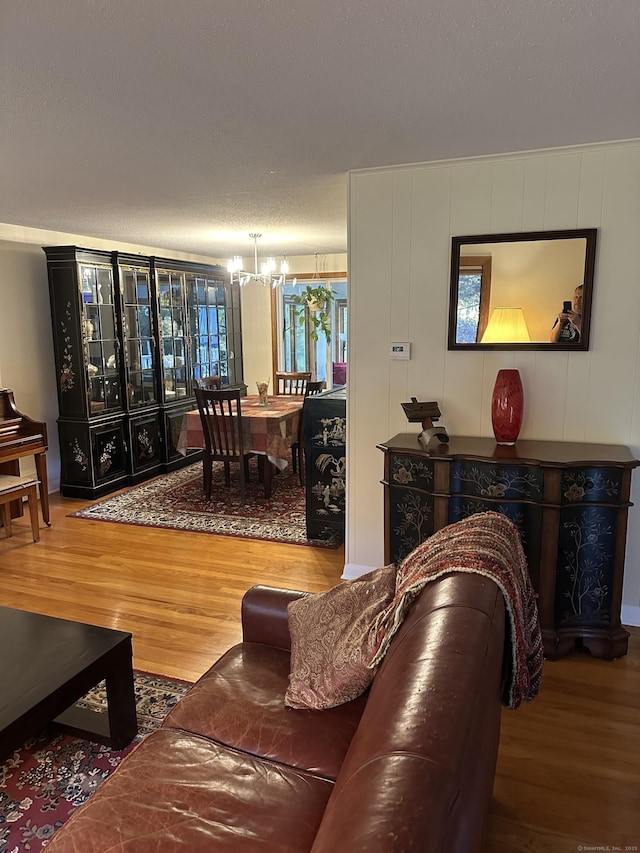 living room with wood-type flooring and a notable chandelier