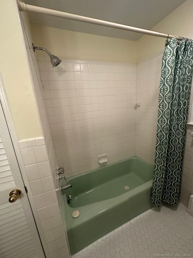 bathroom with tile patterned floors and shower / tub combo