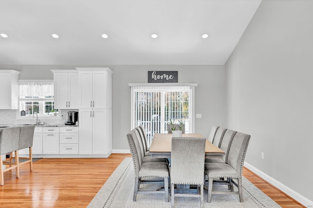 dining area with sink and light hardwood / wood-style floors