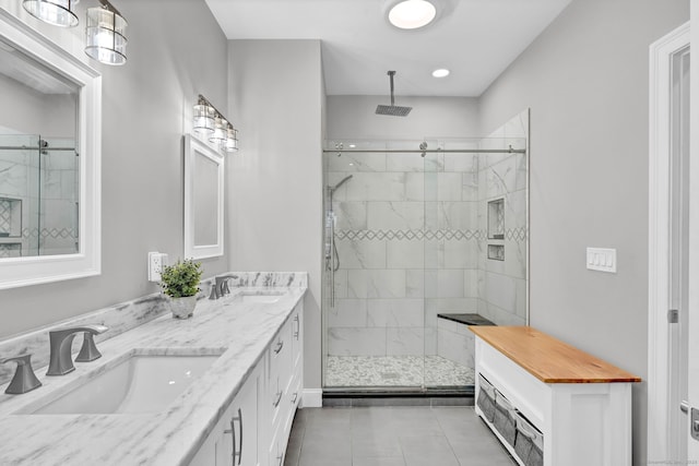 bathroom with an enclosed shower, vanity, and tile patterned flooring